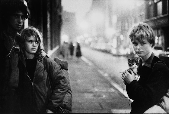 Bruce Davidson ~ London. 1960. Girl with kitten and couple looking on.